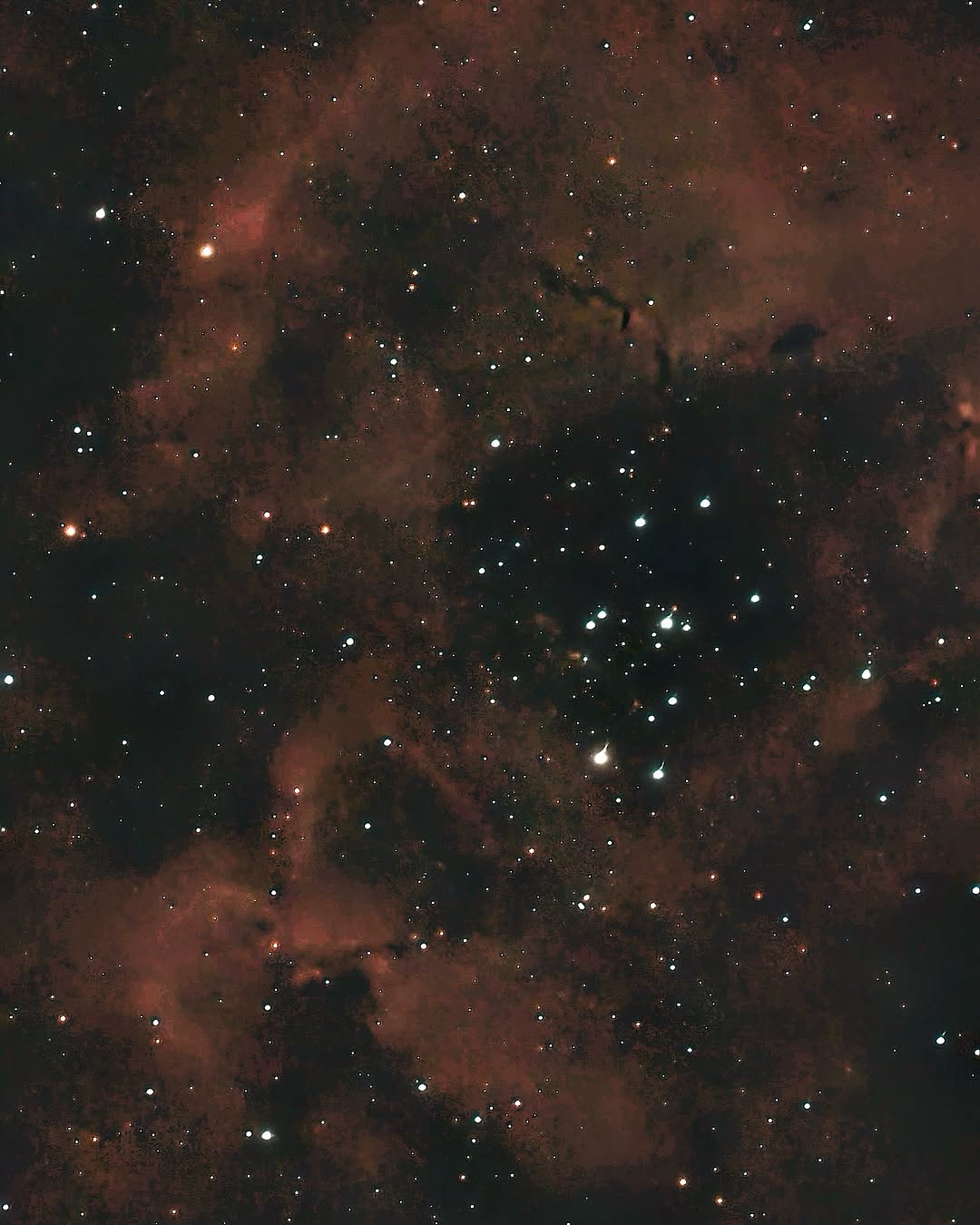 The Rosette Nebula photographed through a telescope